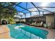 Inviting screened-in pool area with lounge chairs, ideal for relaxation and entertainment at 12542 Idaho Woods Ln, Orlando, FL 32824