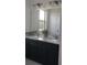 Bathroom with granite countertops, double sinks, and a large mirror at 1292 Hilltop Pl, St Cloud, FL 34772