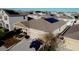 Aerial view of a house with solar panels on roof, driveway with off-road vehicle, and manicured landscaping at 153 Taft Dr, Davenport, FL 33837