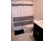 Bright bathroom featuring a toilet and black-and-white striped shower curtain at 153 Taft Dr, Davenport, FL 33837