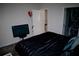 Bedroom featuring dark bedding and a TV, showcasing a simple and comfortable space at 153 Taft Dr, Davenport, FL 33837