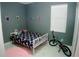 A bedroom with a bicycle parked, window, and toys displayed at 153 Taft Dr, Davenport, FL 33837