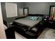 Modern bedroom with an unique platform bed, sleek dresser, and gray walls at 153 Taft Dr, Davenport, FL 33837