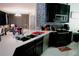 Open-concept kitchen with stainless steel appliances, undermount sink and breakfast bar, ready for entertaining at 153 Taft Dr, Davenport, FL 33837