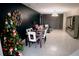 Open-concept dining and living room with modern lighting and dark accent wall, showcasing ample living space at 153 Taft Dr, Davenport, FL 33837