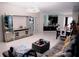 Spacious living room with an open-concept design, modern lighting, and seamlessly flows into the kitchen at 153 Taft Dr, Davenport, FL 33837