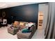 Open-plan living space with a gray sectional sofa, adjacent dining area, and bathroom entrance at 153 Taft Dr, Davenport, FL 33837