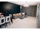Spacious living room with gray sectional sofa, modern lighting, and dark accent wall, ready for relaxation at 153 Taft Dr, Davenport, FL 33837