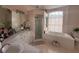 Bright bathroom features dual sinks, a walk-in shower, and a large soaking tub at 216 Boxwood Dr, Davenport, FL 33837