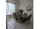 Elegant dining room with a modern light fixture, large windows, and tile flooring at 216 Boxwood Dr, Davenport, FL 33837