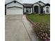 Stylish home exterior boasts a two-car garage, well-manicured lawn, and eye-catching black-and-white trim at 216 Boxwood Dr, Davenport, FL 33837