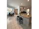 Open-concept kitchen with island seating flows into the dining and living areas at 216 Boxwood Dr, Davenport, FL 33837