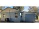 Backyard featuring blue cinderblock exterior, white trim, and a small grassy area at 217 W Chelsea St, Deland, FL 32720