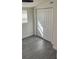 Bedroom featuring laminate floors, a window with blinds, and a closet at 217 W Chelsea St, Deland, FL 32720