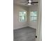 Comfortable bedroom with laminate floors, two windows, and a ceiling fan at 217 W Chelsea St, Deland, FL 32720
