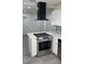 Modern kitchen featuring an island with stainless steel appliances, and white cabinets at 217 W Chelsea St, Deland, FL 32720