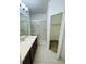 Bathroom featuring a single sink vanity, a walk-in shower, and a walk-in closet at 2242 Seven Oaks Dr, St Cloud, FL 34772