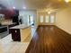 Spacious living room and kitchen with stainless appliances, ample counter space, and hardwood floors at 2242 Seven Oaks Dr, St Cloud, FL 34772
