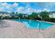 Community pool surrounded by brick pavers and featuring lounge chairs at 2242 Seven Oaks Dr, St Cloud, FL 34772