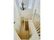 Well-lit staircase with carpeted steps and a decorative chandelier at 2242 Seven Oaks Dr, St Cloud, FL 34772