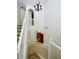 Elegant staircase with white banister, a chandelier and views of the living area below at 2242 Seven Oaks Dr, St Cloud, FL 34772