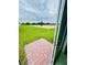 View from a patio door of a grassy backyard leading up to the horizon at 2505 Merseyside Ct, Haines City, FL 33844
