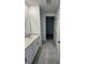 Bathroom with modern vanity, tile flooring, and a glimpse into the walk-in closet at 2505 Merseyside Ct, Haines City, FL 33844