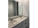 Well-lit bathroom featuring double sinks, modern fixtures, and neutral color scheme at 2505 Merseyside Ct, Haines City, FL 33844