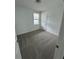 Cozy bedroom featuring neutral carpet, a window, and a white door at 2505 Merseyside Ct, Haines City, FL 33844