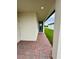 Covered front entrance featuring brick pavers and a stylish front door, offering a welcoming approach at 2505 Merseyside Ct, Haines City, FL 33844