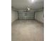 Empty garage space with concrete floor and a closed garage door at 2505 Merseyside Ct, Haines City, FL 33844