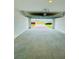 View of the garage opening to a paved driveway and the neighborhood street at 2505 Merseyside Ct, Haines City, FL 33844