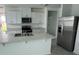 Modern kitchen featuring white cabinetry, stainless steel appliances, and a large island, perfect for entertaining at 2505 Merseyside Ct, Haines City, FL 33844