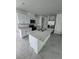 Modern kitchen with white cabinets, stainless steel appliances, and a large island with a double sink at 2505 Merseyside Ct, Haines City, FL 33844