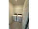 Functional laundry room featuring modern washer and dryer, plus convenient wire shelving for storage at 2505 Merseyside Ct, Haines City, FL 33844