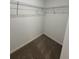 Small walk-in closet featuring wire shelving and plush carpeting at 2505 Merseyside Ct, Haines City, FL 33844