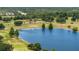Picturesque lake surrounded by golf course greenery and mature trees at 2580 Gallardia Dr, Lake Wales, FL 33898
