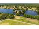 Beautiful aerial shot of the golf course lake with a small island and lush greenery at 2580 Gallardia Dr, Lake Wales, FL 33898