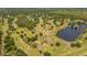 Overhead view of a lush golf course with a serene lake and a wooden bridge at 2580 Gallardia Dr, Lake Wales, FL 33898
