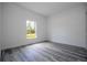 Bright bedroom with gray wood-look flooring and a window offering natural light at 2580 Gallardia Dr, Lake Wales, FL 33898