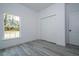 Bright bedroom featuring gray flooring, a window and a double door closet at 2580 Gallardia Dr, Lake Wales, FL 33898