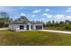 New construction with a gray roof, white siding, black trim, and a well-manicured lawn at 2580 Gallardia Dr, Lake Wales, FL 33898