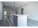 Bright kitchen island with white cabinets, quartz countertops and modern black faucet. Open concept living space at 2580 Gallardia Dr, Lake Wales, FL 33898