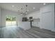 Modern kitchen featuring white cabinets, stainless steel appliances, a center island, and sliding glass doors at 2580 Gallardia Dr, Lake Wales, FL 33898