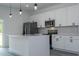 Modern kitchen featuring white cabinets, stainless steel appliances, and speckled countertops at 2580 Gallardia Dr, Lake Wales, FL 33898