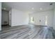 Bright living room with light gray flooring and a white entry door with sidelights at 2580 Gallardia Dr, Lake Wales, FL 33898