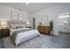 Bright bedroom features hardwood floors, neutral decor, and a serene view of the ensuite bathroom at 2580 Gallardia Dr, Lake Wales, FL 33898