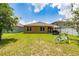 Spacious backyard featuring a barbecue area, lush lawn, and a charming blue bicycle accenting the outdoor space at 2726 Harmonia Hammock Rd, Harmony, FL 34773