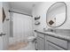 Neutral bathroom featuring a shower with curtain and granite vanity at 2726 Harmonia Hammock Rd, Harmony, FL 34773