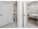 Clean half-bathroom adjacent to bedroom with tile flooring and convenient access to the primary suite at 2726 Harmonia Hammock Rd, Harmony, FL 34773